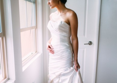 Woman in Wedding Dress Next to Window